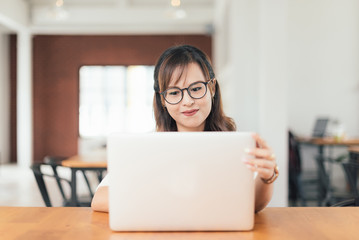 Asian young business freelance woman happiness working online business with laptop and cell phone in cafe shop. Working, Success, happiness concept.