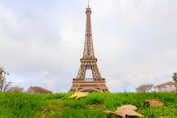 Fototapeta premium PARIS, FRANCE - DECEMBER 11, 2014: Aerial view of Eiffel Tower with maple leaves amoung Avenue Anatole France & Avenue Pierre Loti most visited monument in France and the most famous symbol of Paris