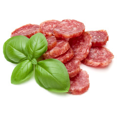 Salami smoked sausage slices and basil leaves isolated on white background cutout