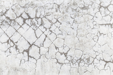 Old concrete wall with cracked white paint