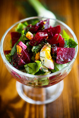Salad from boiled beet with eggs and fresh vegetables
