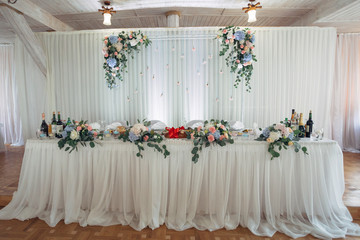 The many flowers stand on the wedding table