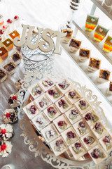 The cakes,cup of jellies and tiramisue stand on the banquet table