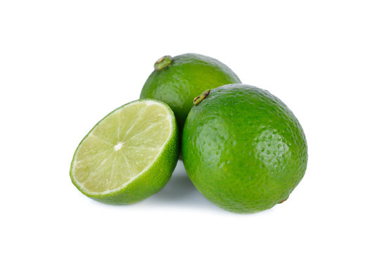 whole and half cut fresh lime on white background