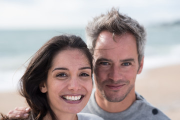 Obraz premium Portrait of a middle-aged couple having fun on the beach