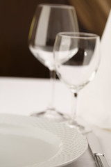 Meal setting arranged in elegant way, Wineglasses and silverware, Selective focus with soft light