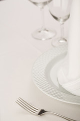 Fork and plate arranged in elegant setting, Selective focus with soft light