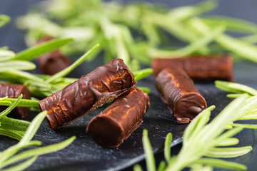 Homemade chocolate candy sticks with rosemary