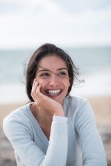 Portrait of a beautiful young brunette woman on the beach