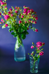 The beautiful vases with flowers  stand on the table