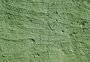 Green color weathered plaster wall surface.