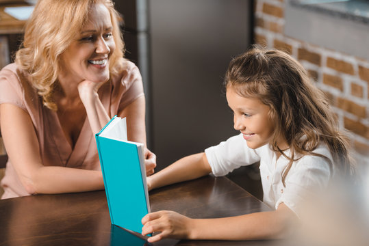 Grandmother And Granddaughter Reading Book