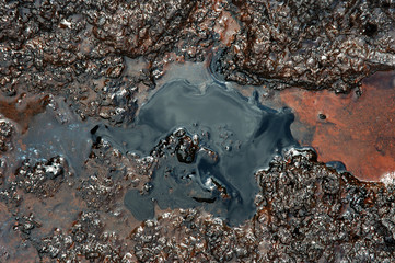 Spills of crude oil on the soil surface - environment pollution.