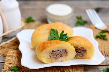 Fried ground beef and potato patties on a white plate. How to make potato patties stuffed with...