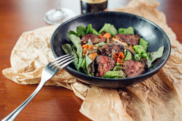 Grilled pork ribs on wooden board, shallow depth of field
