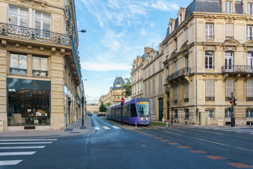 Fototapeta na wymiar Tram on the streets and Architecture of Reims a city in the Champagne-Ardenne region of France.