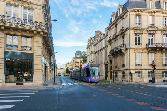 Tram on the streets and Architecture of Reims a city in the Champagne-Ardenne region of France.