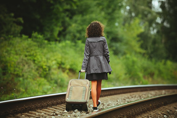 girl traveling on train rails 