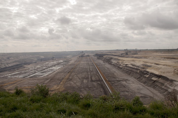 Germany, North Rhine Westphalia, -june 2017:  ground excavator in action moving mullock and soil at open pit coal mine; Germany,for winning brown coal