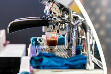 Espresso pouring from coffee machine.