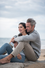 Portrait of a middle-aged couple sitting on the beach