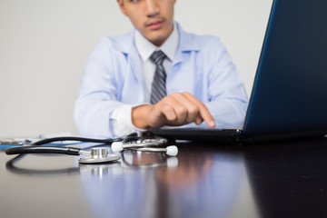 medical doctor working with laptop computer on white background