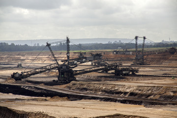 Germany, North Rhine Westphalia, -june 2017:  ground excavator in action moving mullock and soil at open pit coal mine; Germany,for winning brown coal