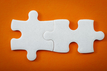 Obraz premium The whole is greater than the sum of its parts concept with two blank puzzle pieces interlocked with copy space for text on the empty puzzles that interlock to illustrate 2 ideas that work together