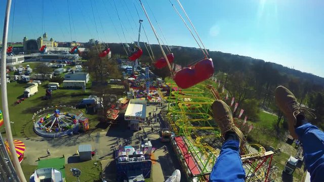 POV GoPro - a man and his girlfriend on a swing ride, legs outstretched