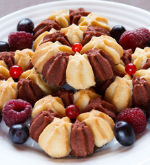 Biscuit with fresh berries on white plate. Selective focus
