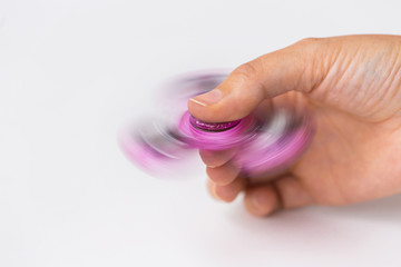 close up of hand playing with fidget spinner