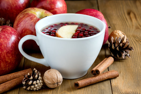 Autumn winter food concept Close up Cup with hot cinnamone and apple tea Wooden background 