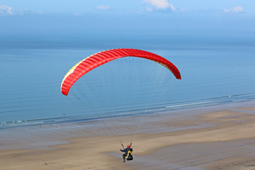Paraglider above the beach
