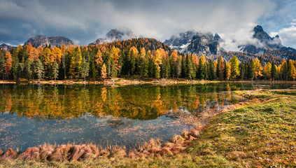 Sunny outdoor scene on Antorno lake. Colorful autumn morning in Dolomite Alps, National Park Tre Cime di Lavaredo, Italy, Europe. Artistic style post processed photo.