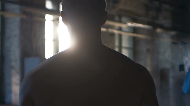 Follow-up Shot of Muscular Shirtless Man Entering Gym in Slow Motion. He's Ripped, Confident and Ready to Start His Training Day. Shot on RED EPIC-W 8K Helium Cinema Camera.