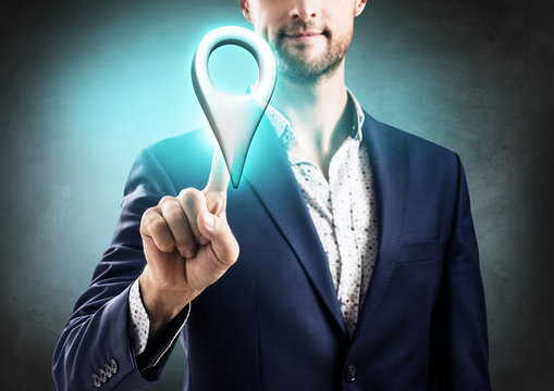 Businessman pointing on indicating location icon.