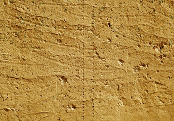 Orange color weathered plaster wall surface.