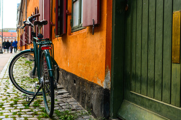 Bicycle near the orange wall of old building in Copenhagen, Denmark. Copenhagen style, Denmark bicycle, european street