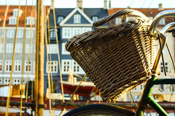 Bicycle with basket on Nyhavn (New Harbour) in Copenhagen, Denmark. Colorful old town architecture. Copenhagen style, European street, Denmark bicycle