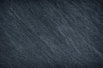 Dark grey / black slate background or texture.