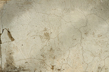 The wall in the cracks with the remains of plaster and paint.