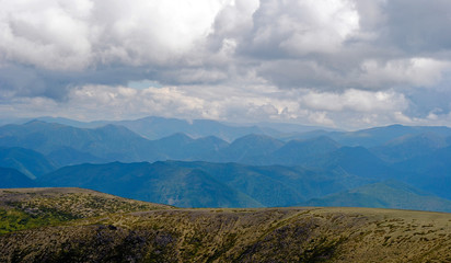Summer mountain landscape. View of the hills and meadows on Lake Baikal, Russia