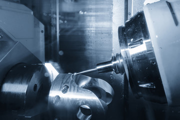 The 5-axis CNC  milling machine  cutting the automotive part with the cutting ballnose tool.Hi-technology machining concept.