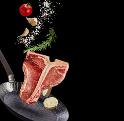 Raw lean healthy T-bone steak with ingredients
