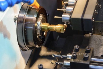 CNC lathe machine or Turning machine cutting the copper part .Hi technology manufacturing