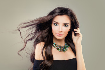 Fashion Model with Perfect Hairstyle and Makeup. Beautiful Model with Long Blowing Healthy Hair