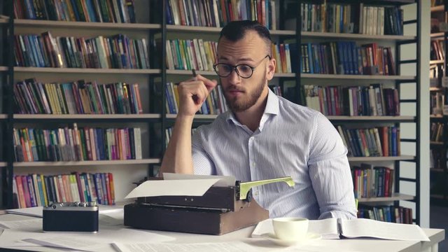 Young writer ponders a book indoors