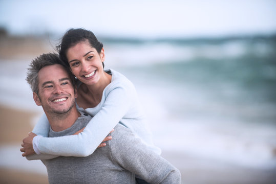 A Beautiful Couple In Their Forties  Walks On The Beach