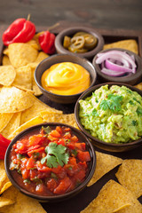 mexican nachos with guacamole, salsa and cheese dip