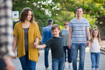 Smiling people of different ages walk in the park